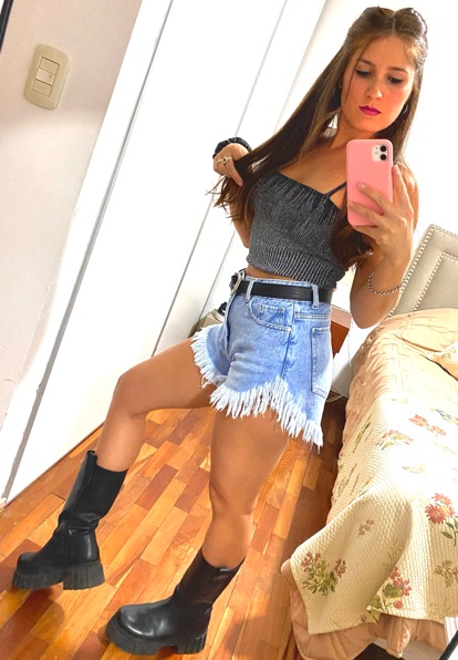 Community host in a casual outfit taking a mirror portrait