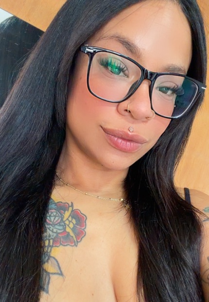 Portrait of a woman with long hair and glasses