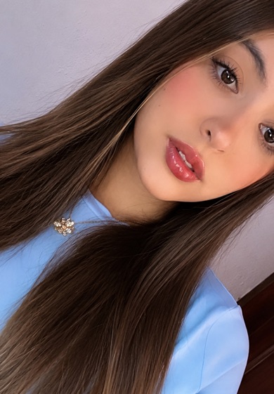 Portrait of a woman with long brown hair in a blue blouse