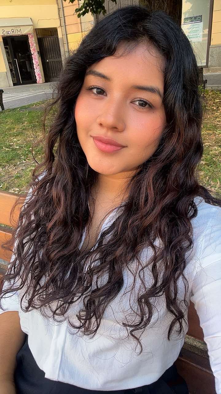 Portrait of a woman with wavy dark hair outdoors
